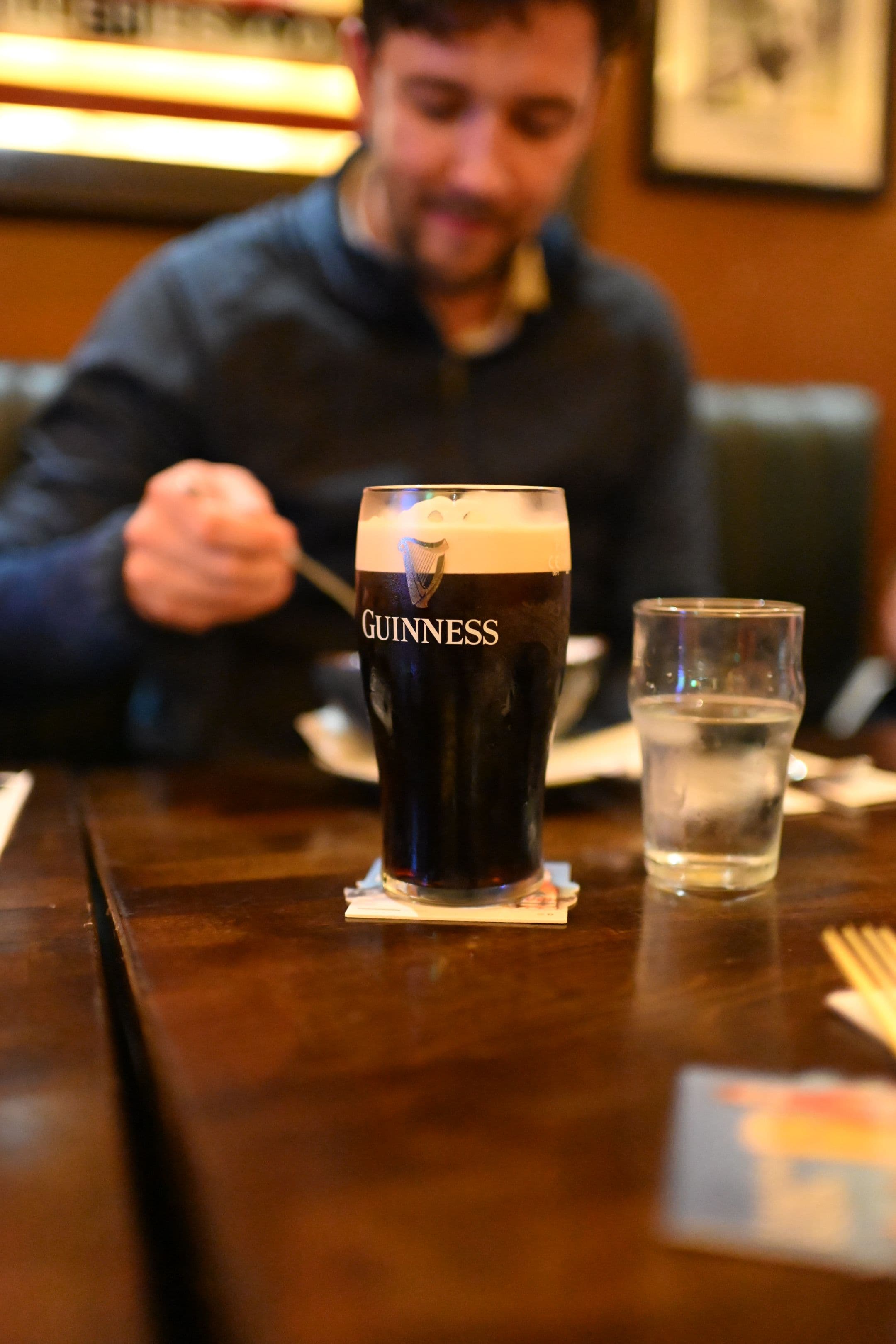 A freshly poured pint of stout settling on a Galway pub counter