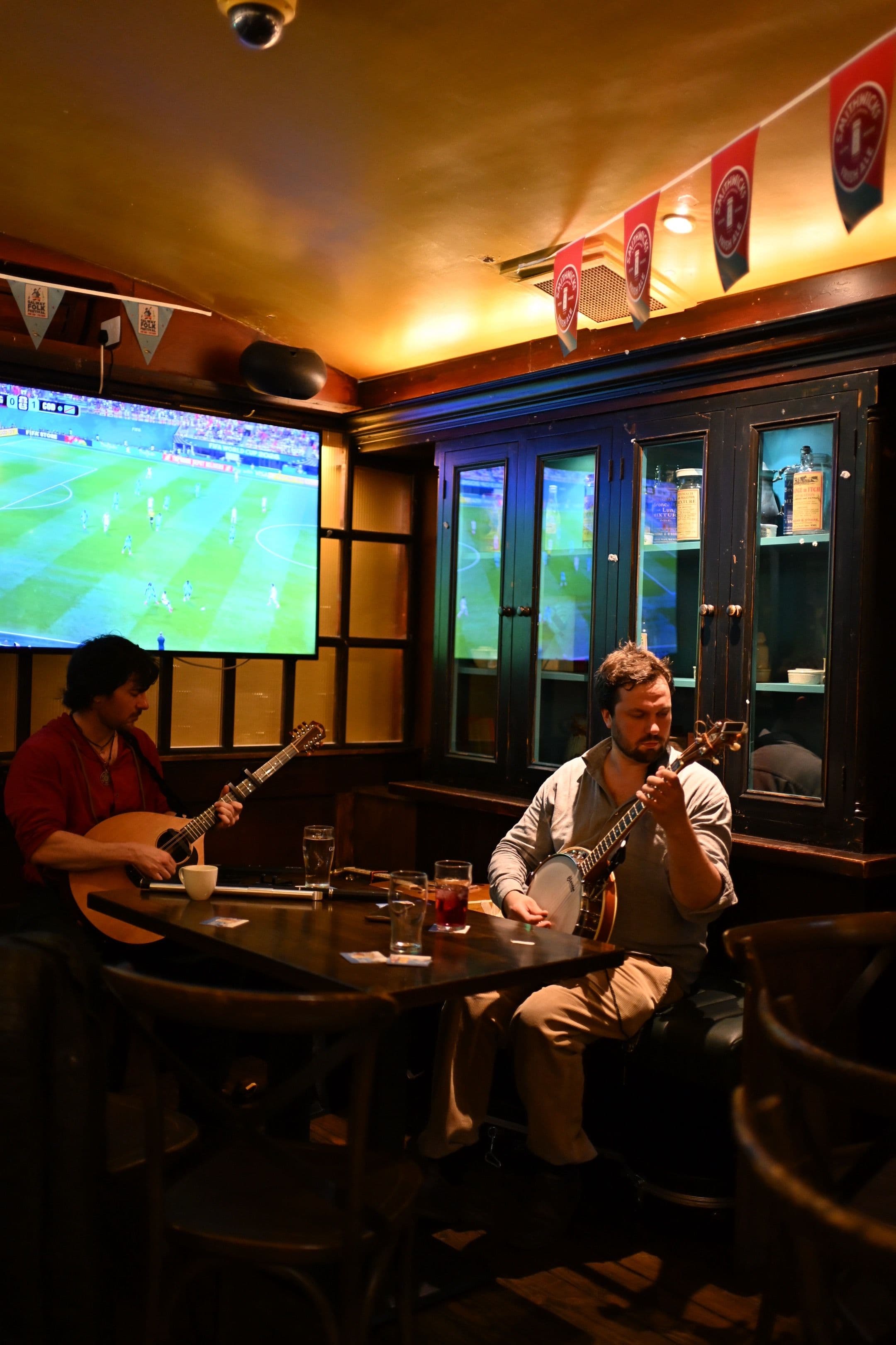 Traditional Irish musicians playing fiddle and banjo in a Galway pub