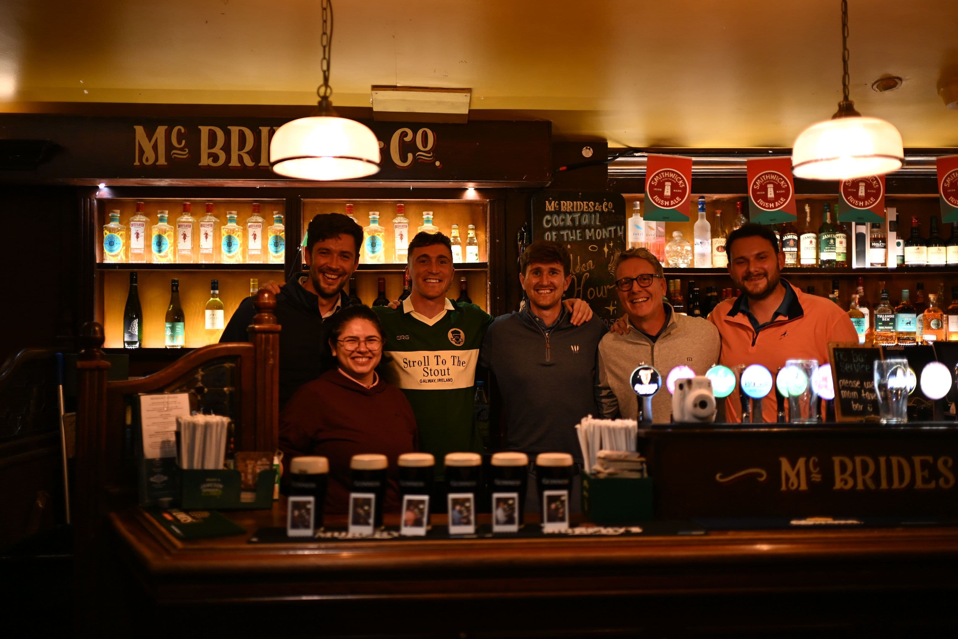 Customers with the pints they had just poured while listening to some good music