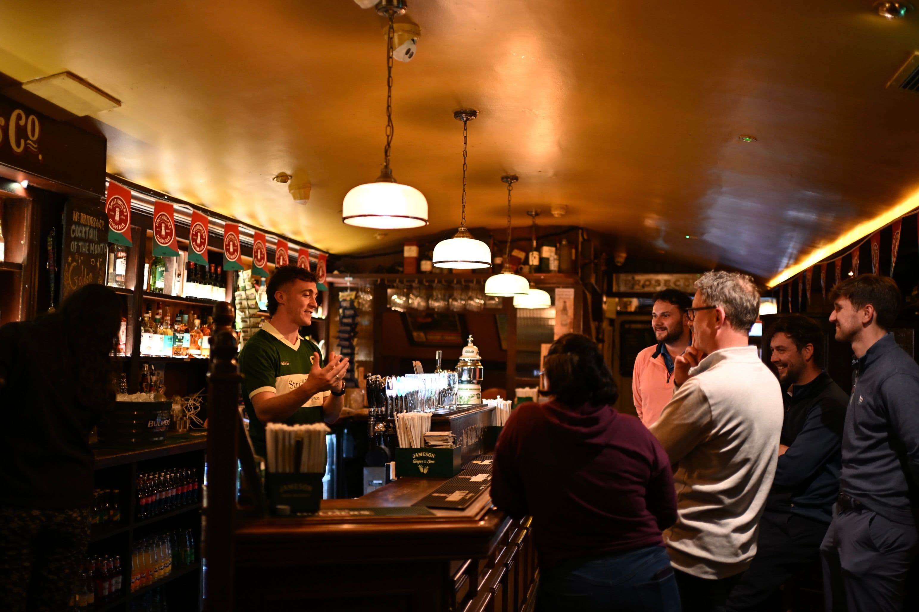 Guest pouring their own pint of Guinness during a private trad session in a Galway pub