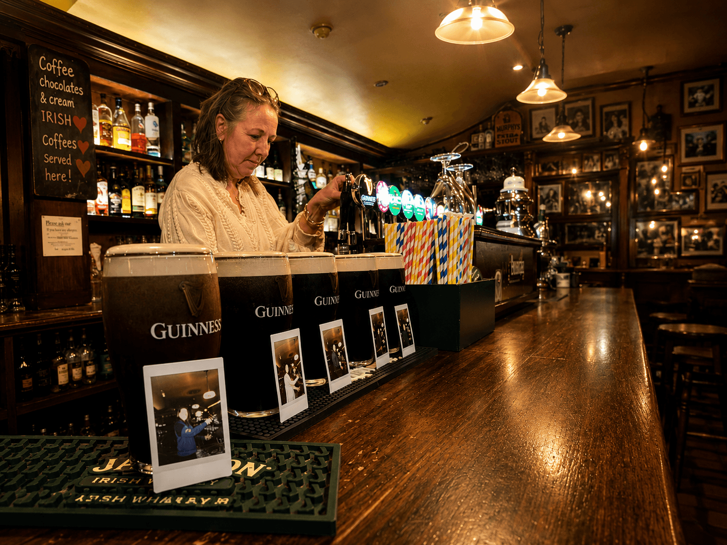 Guest pouring their own pint of Guinness behind the bar in Galway